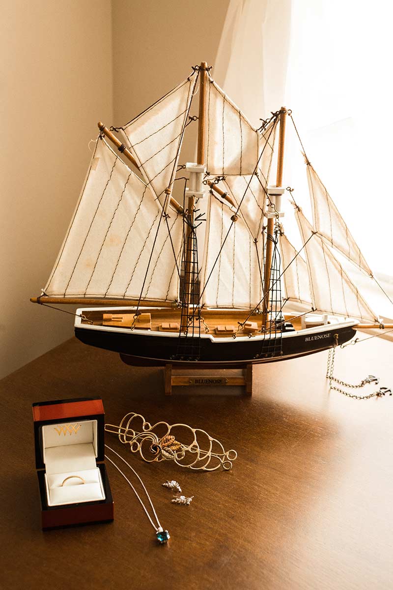 sail boat figuring next to wedding jewelry