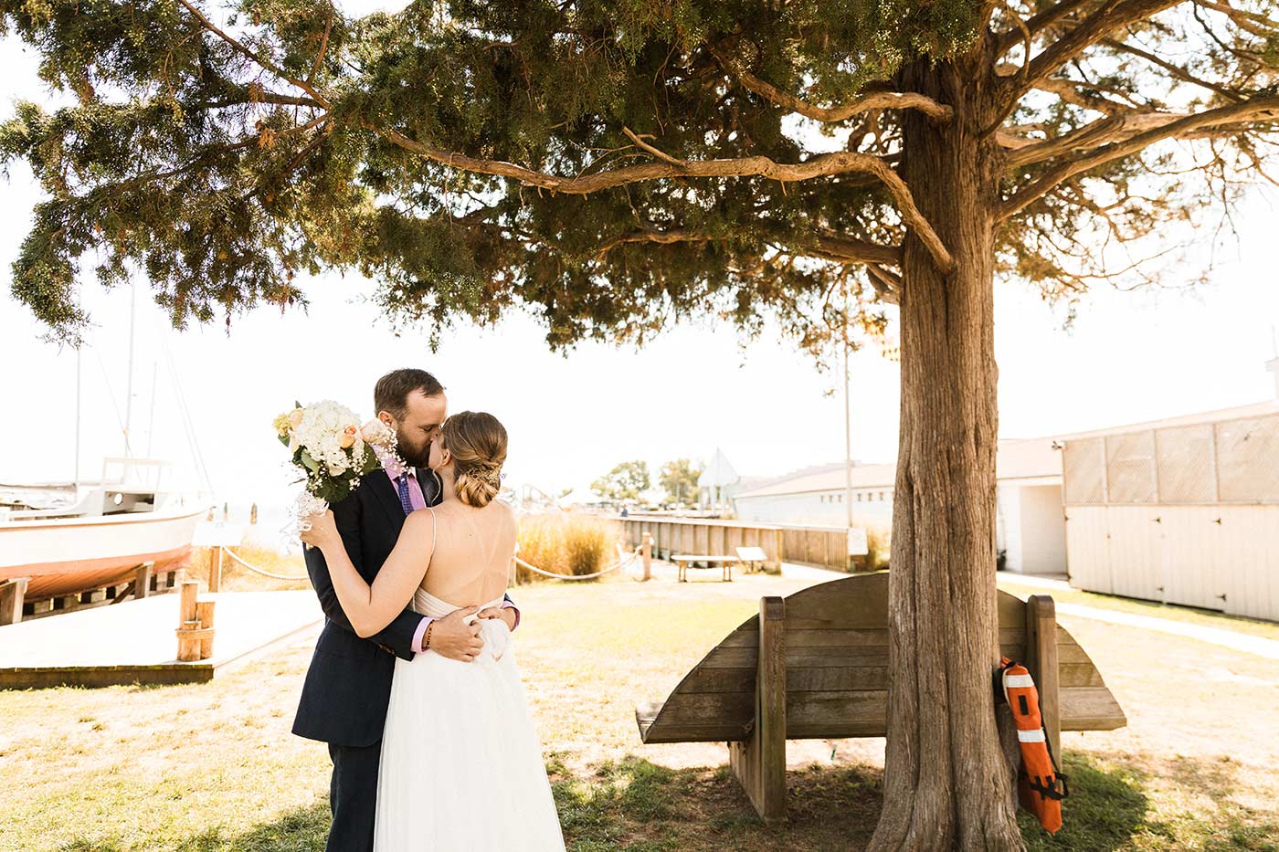 bride and groom under tree