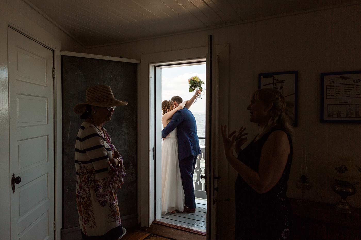 bride and groom on lighthouse balcony