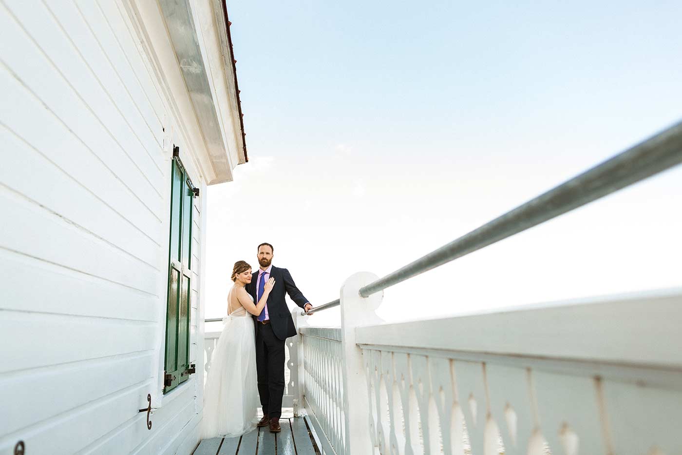 bride and groom on lighthouse balcony
