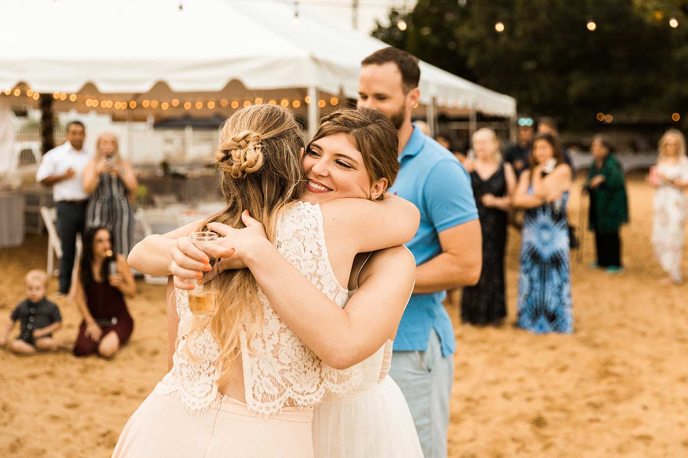 bride hugging sister