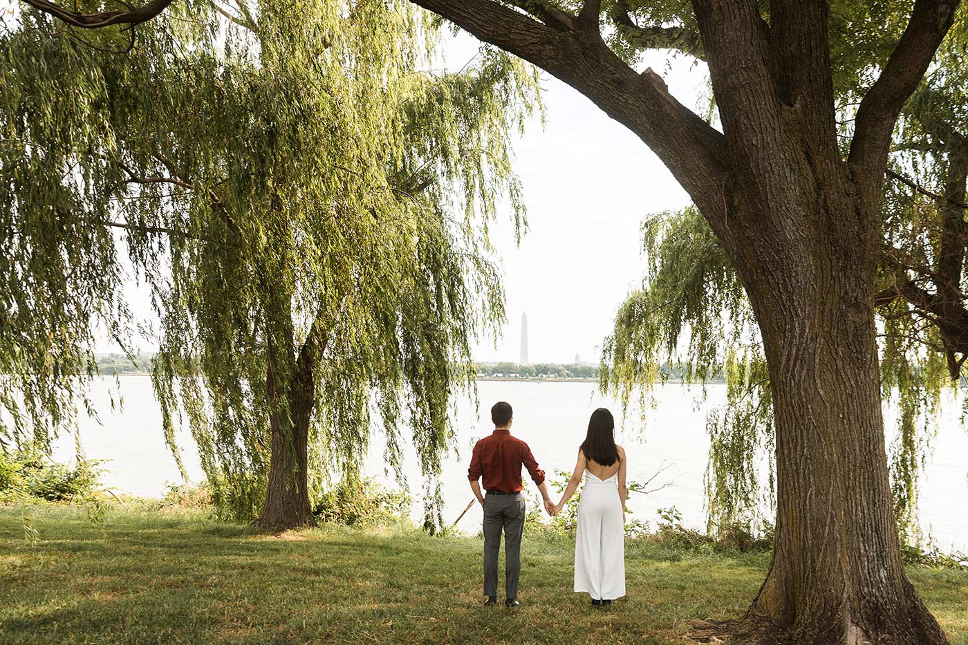 bride and groom looking out at the potomac river and washington monument