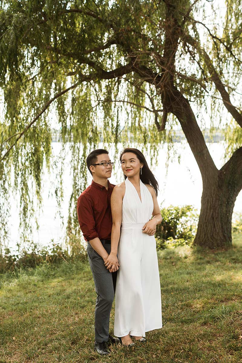 couple under willow trees along the potomac river