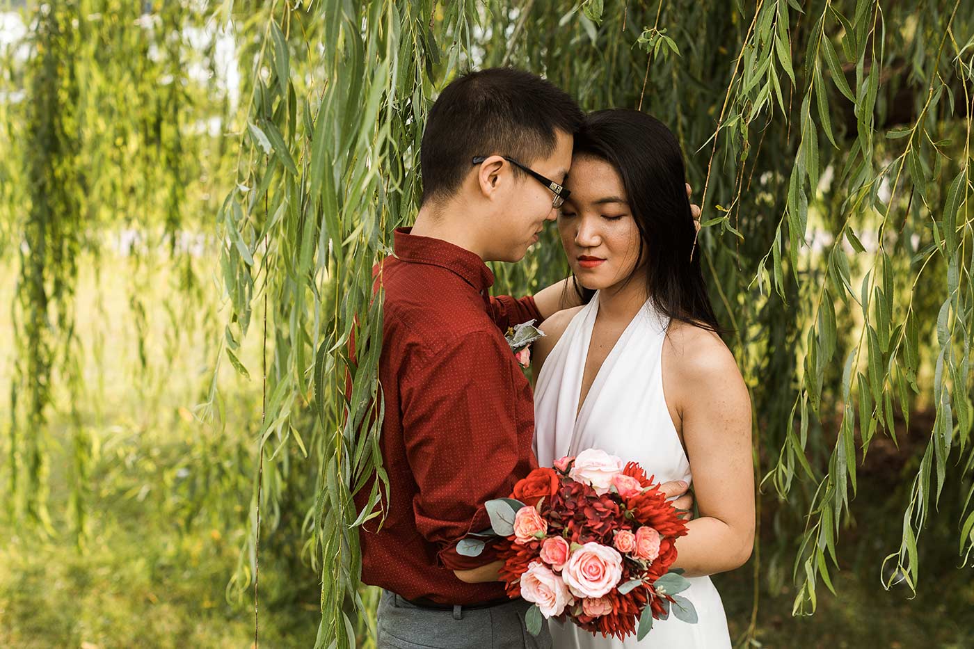 Bride and groom under weeping willow