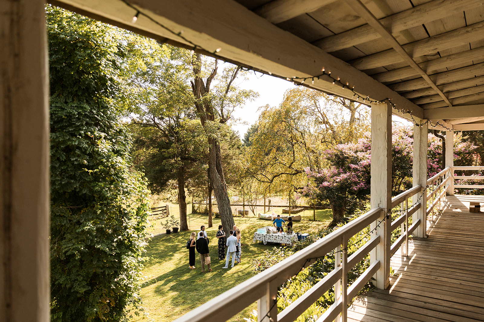 view from porch to people at cocktail hour