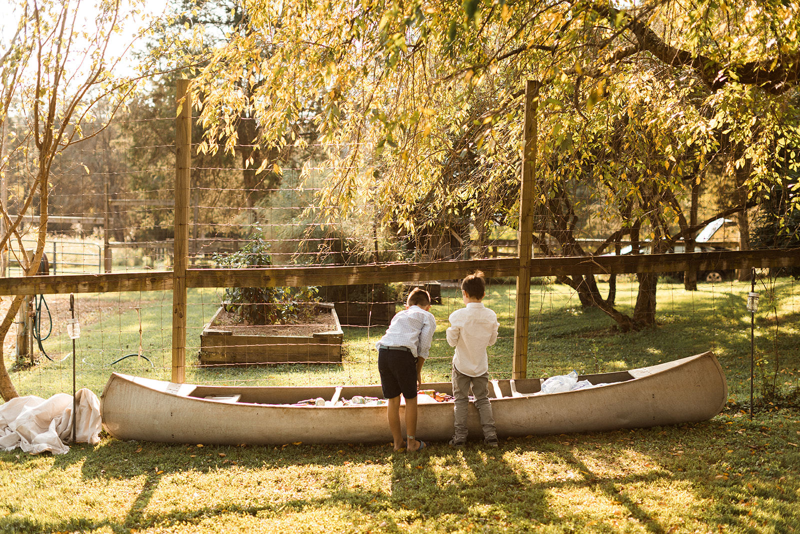 kids pulling drinks out of canoe