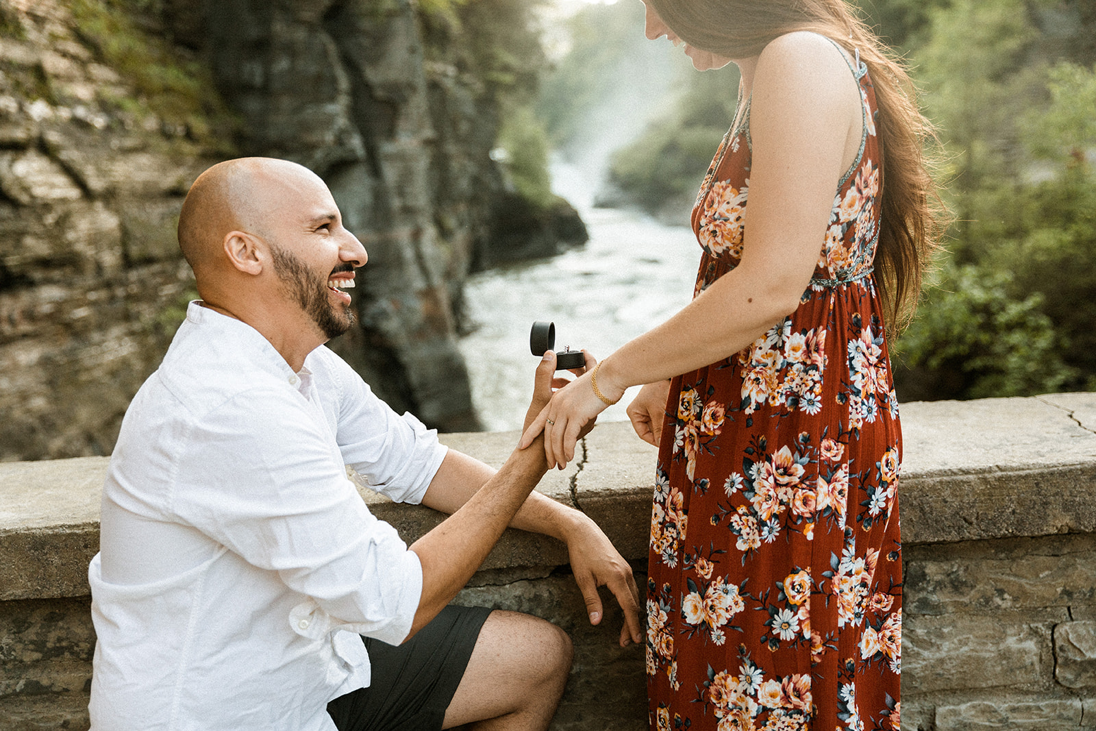 man on knee proposing with ring