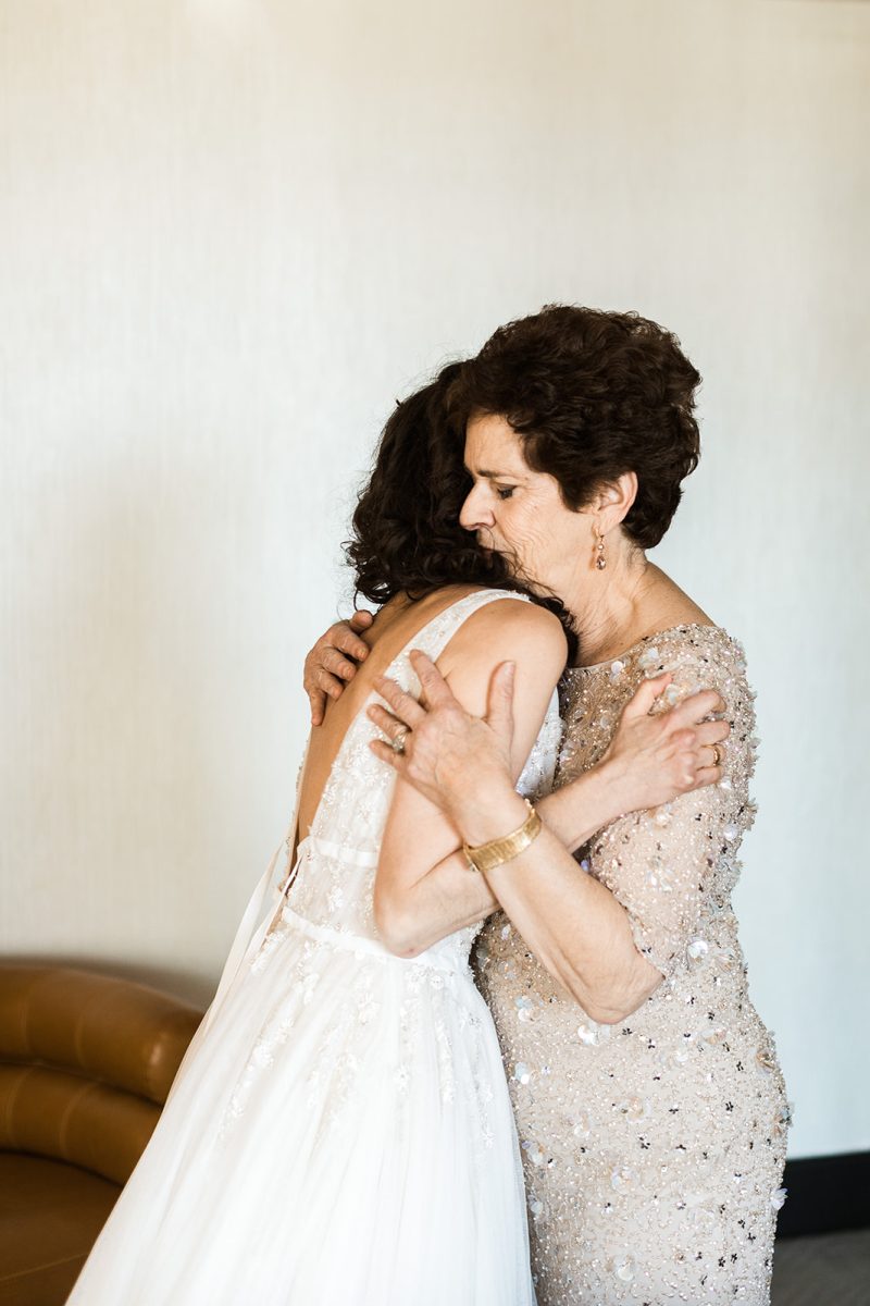 bride and mom hugging