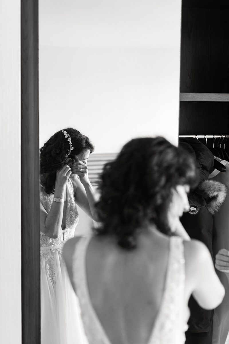 bride putting on earrings