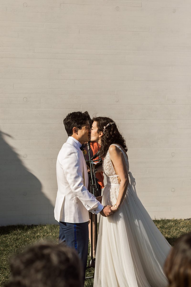 bride and groom first kiss
