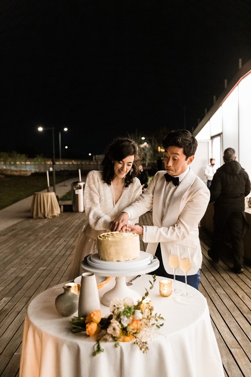 bride and groom cutting cake