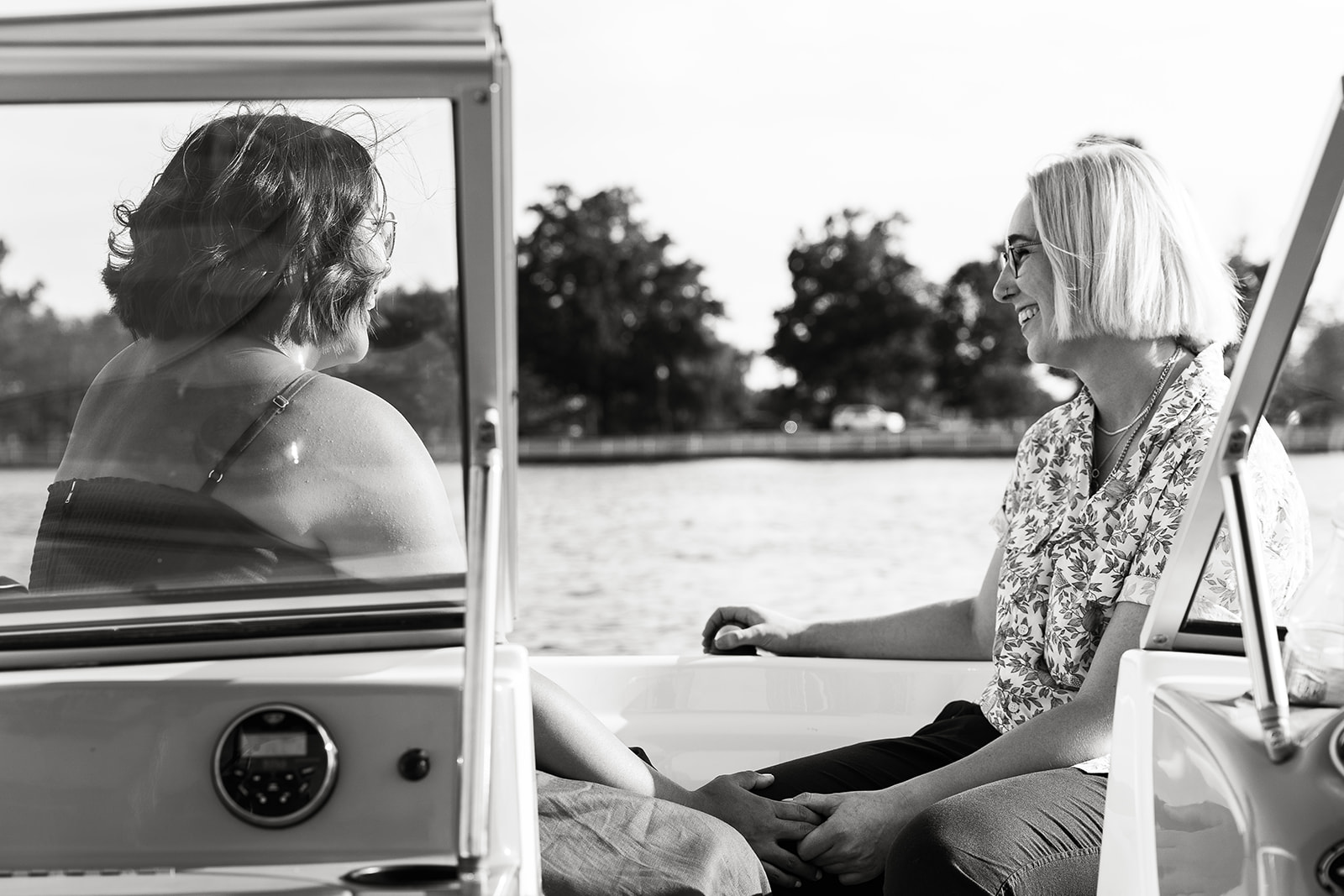 women holding hands on a boat