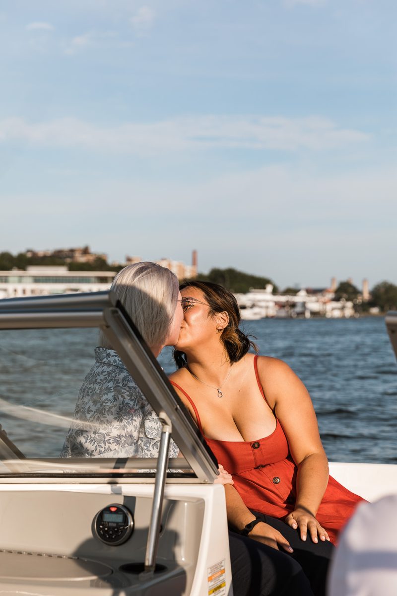 Two women kissing on a boat