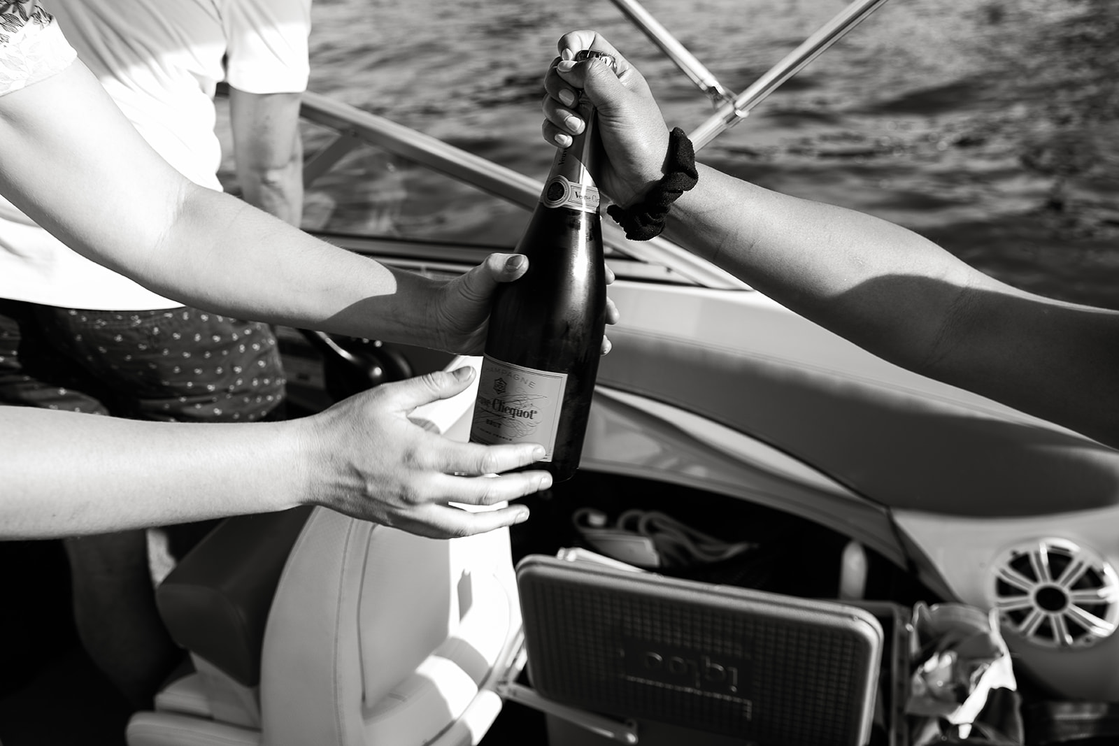 people popping champagne on a boat