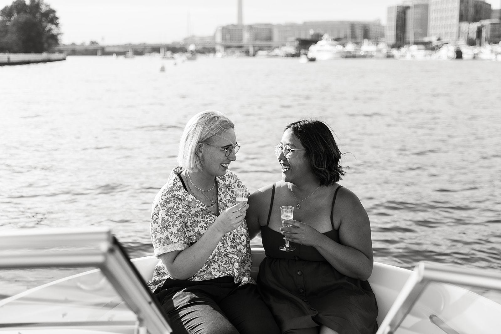lesbian couple drinking champagne on a boat