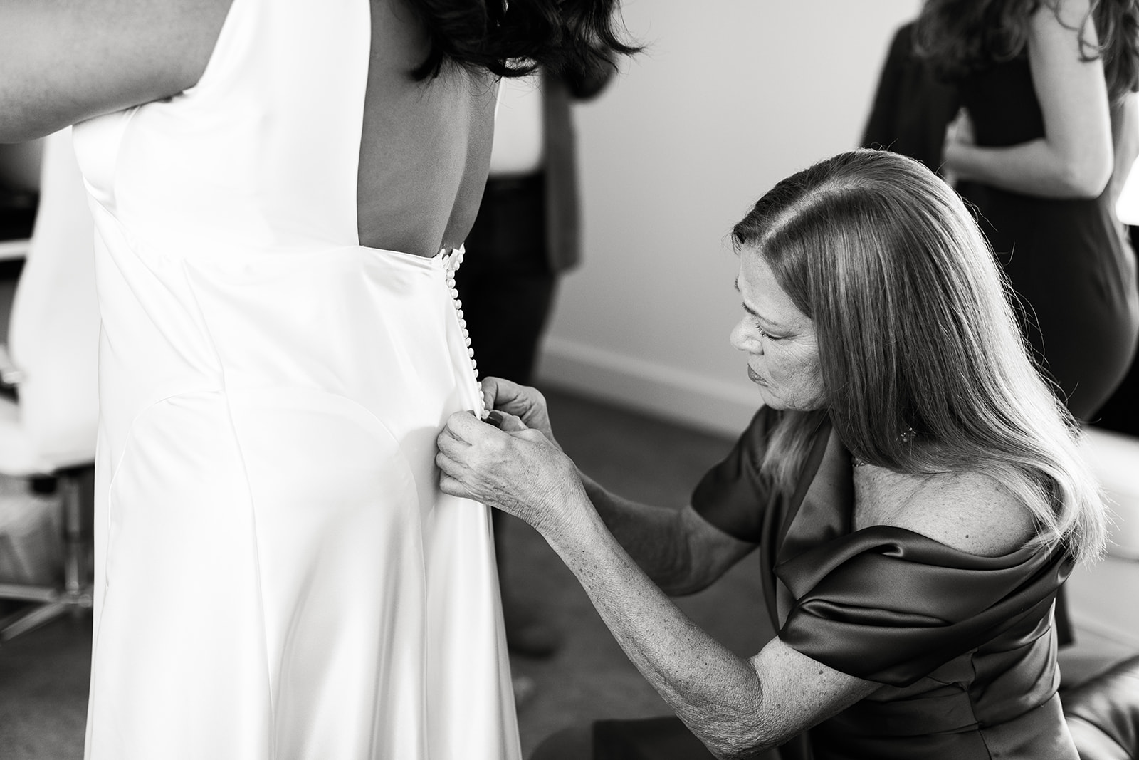 bride's mother buttoning dress