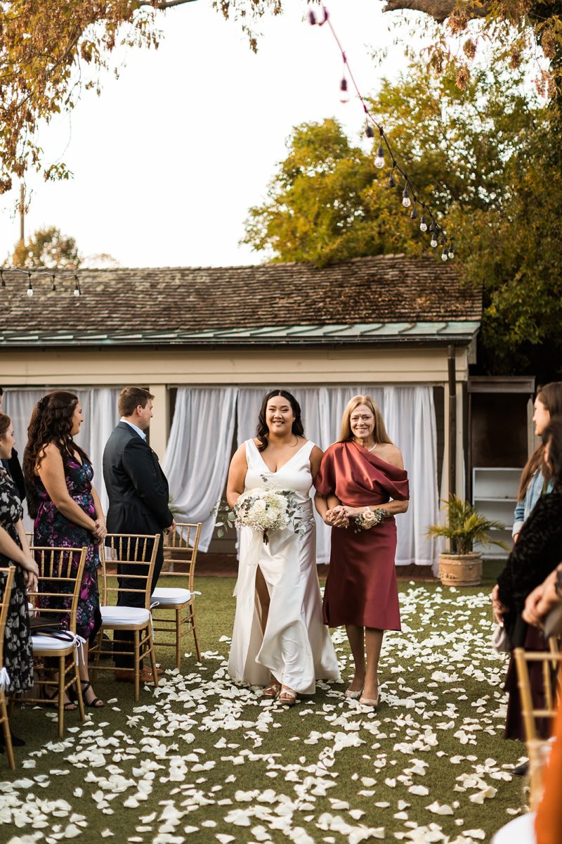 bride walking down aisle with her mom
