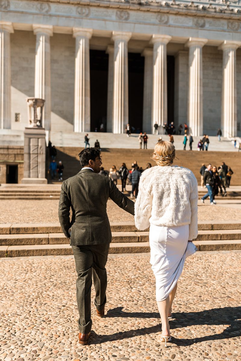 bride and groom walking up steps to lincoln memorial
