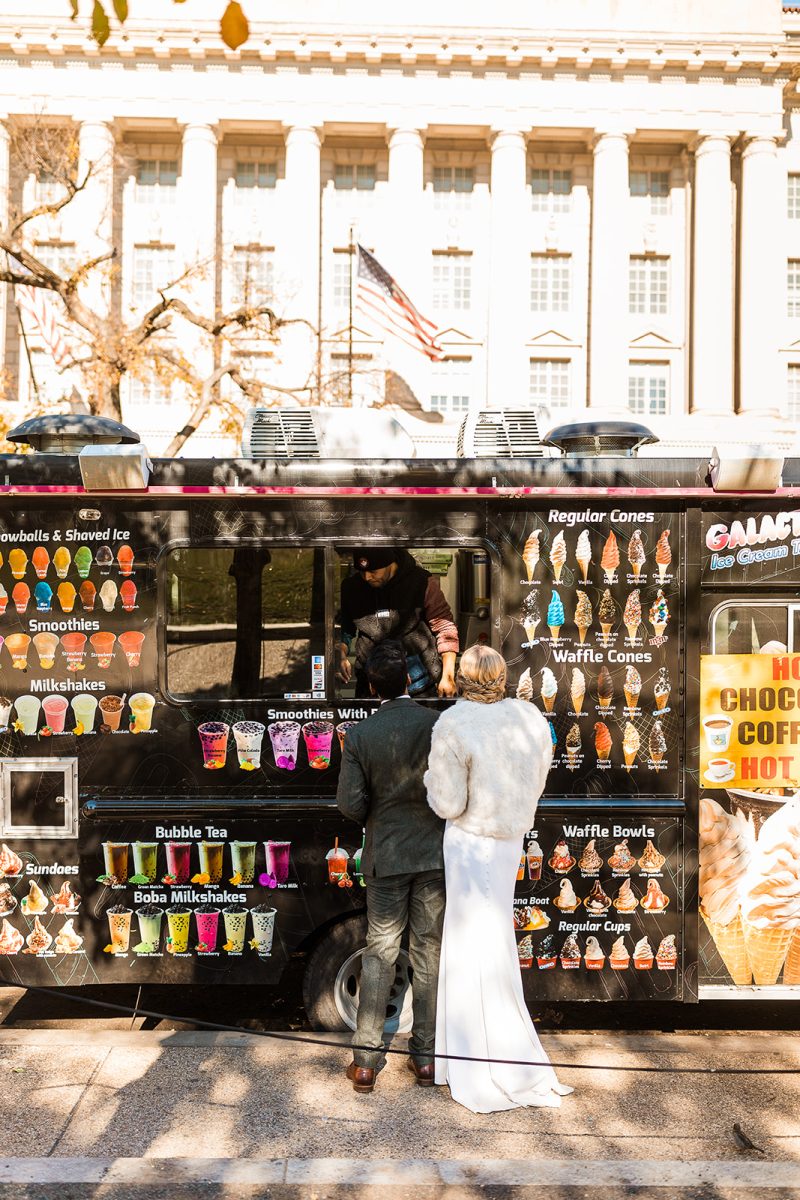bride and groom ordering at ice cream truck