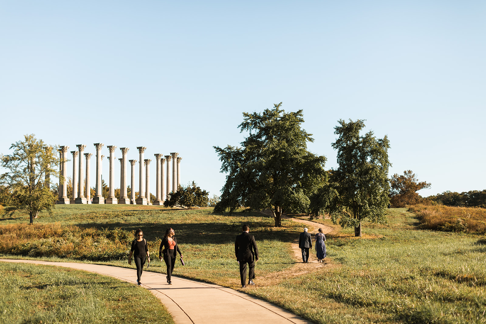 Guests arriving to wedding at National Arboretum with columns in background. 