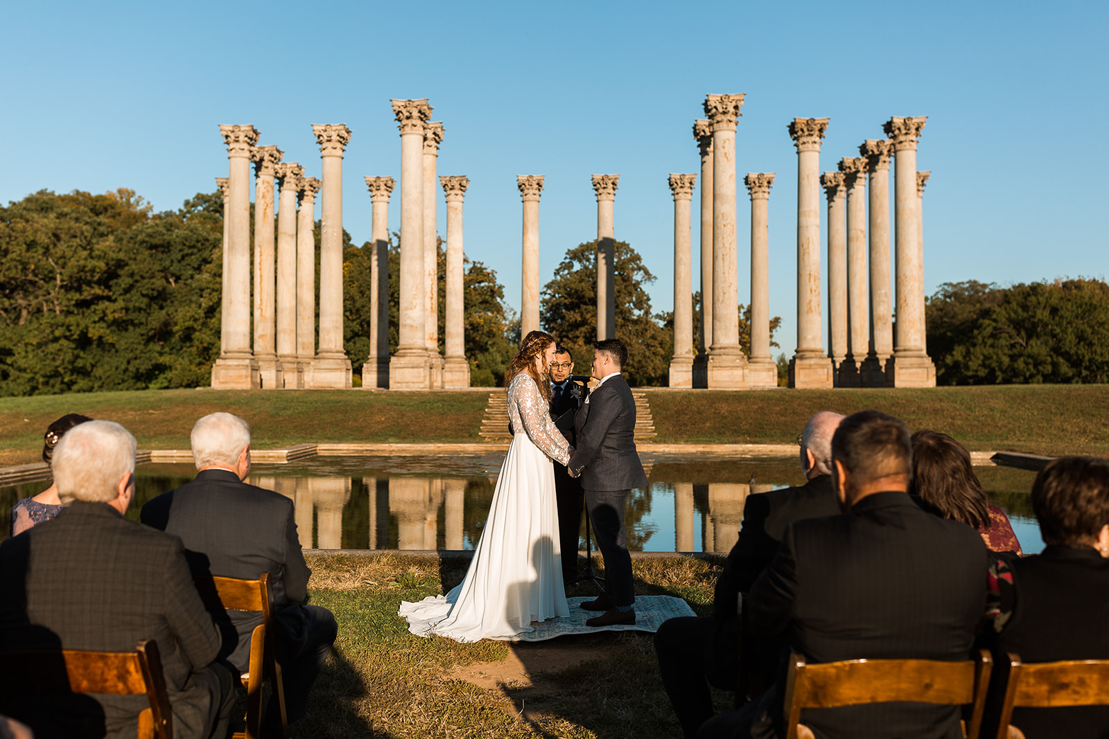 LGBTQ+ wedding ceremony at National Arboretum in Washington DC with columns in the background. 
