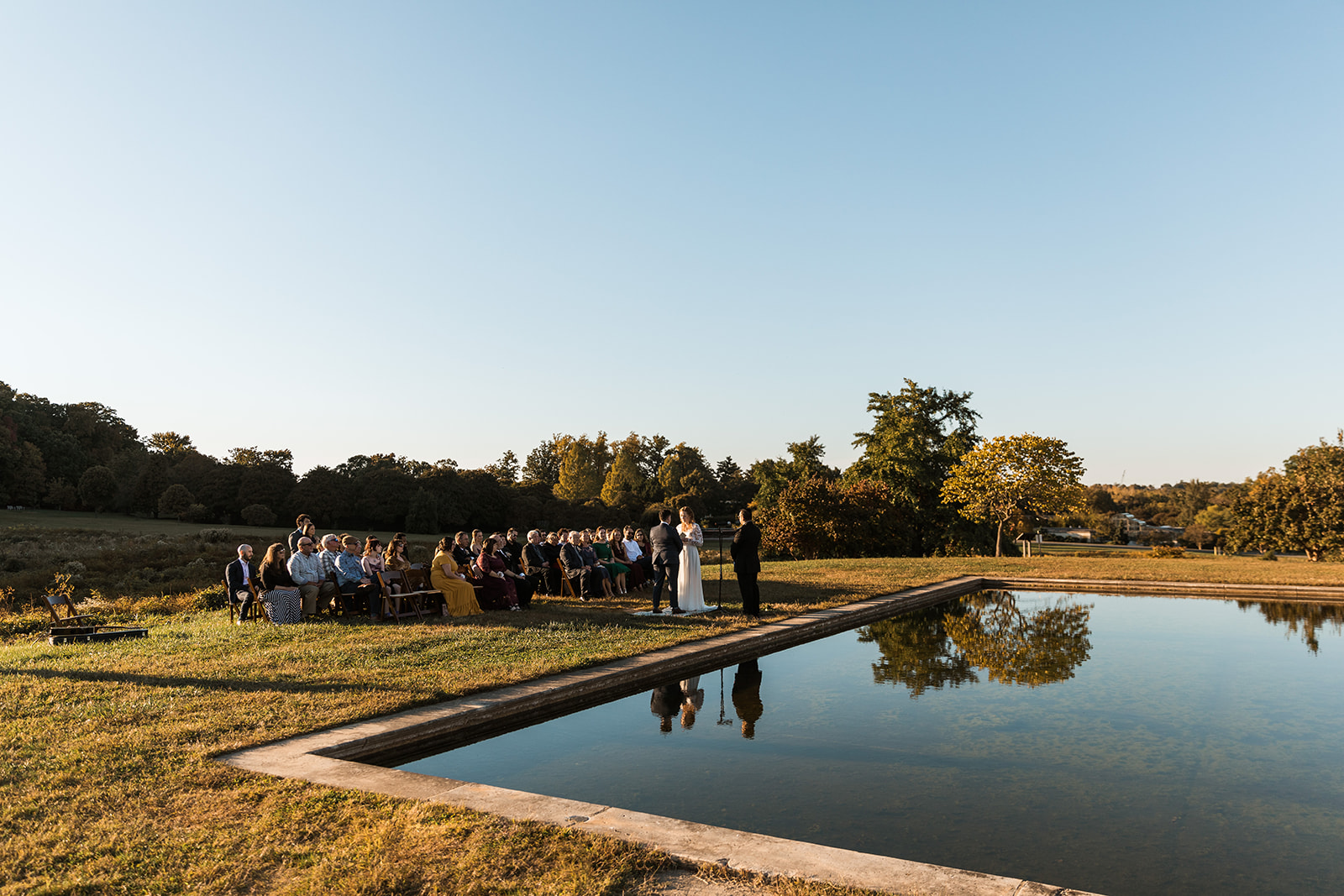 Intimate wedding ceremony next to water feature at National Arboretum. 