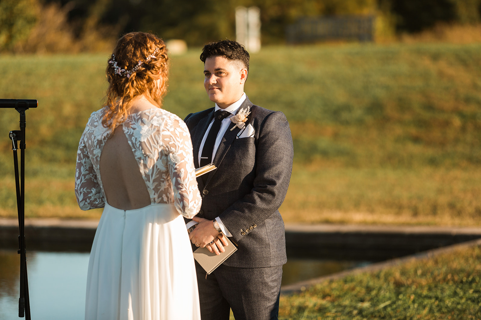 LGBTQ+ couple saying their vows during wedding ceremony. 