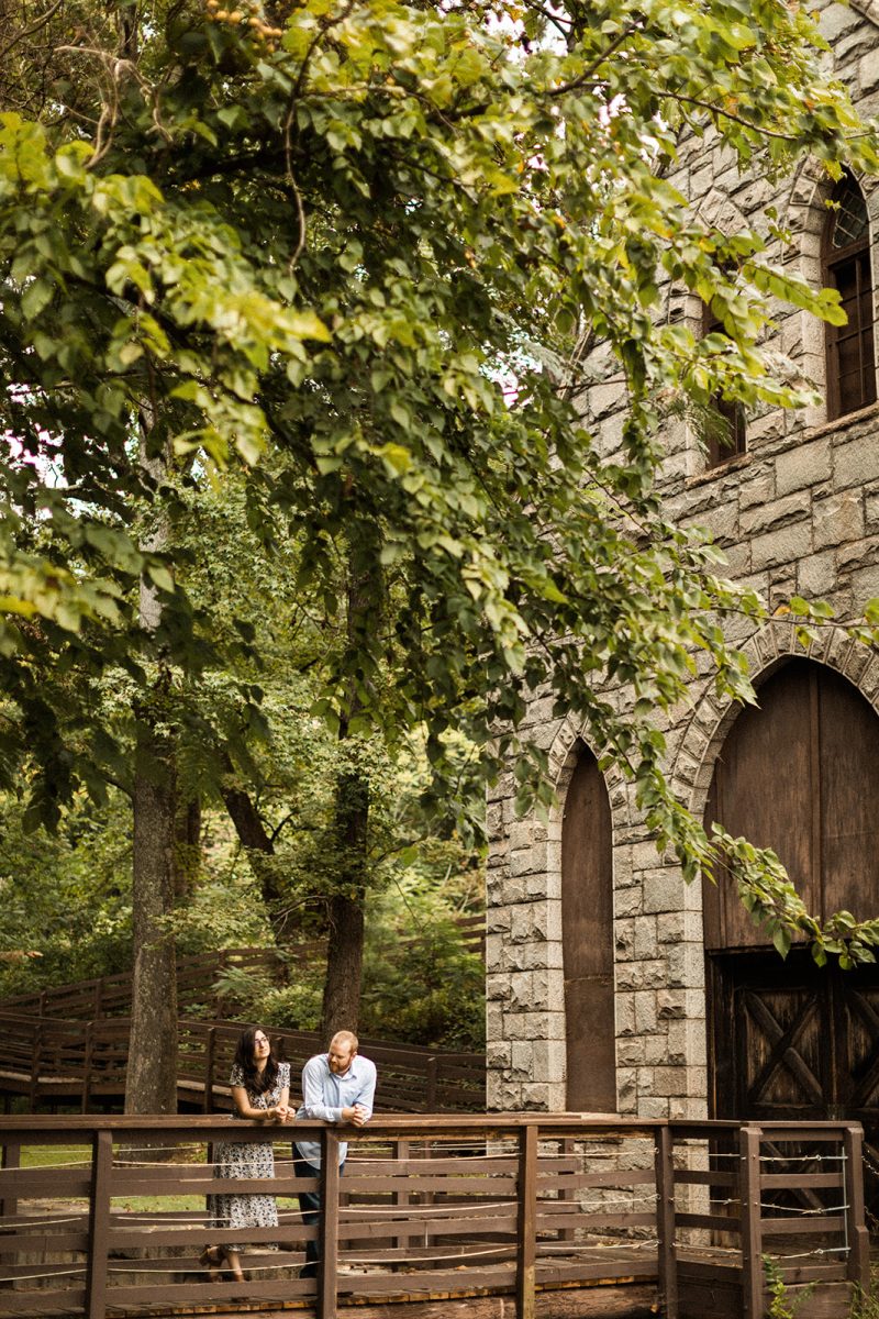 couple leaning on railing of bride at james river pump house