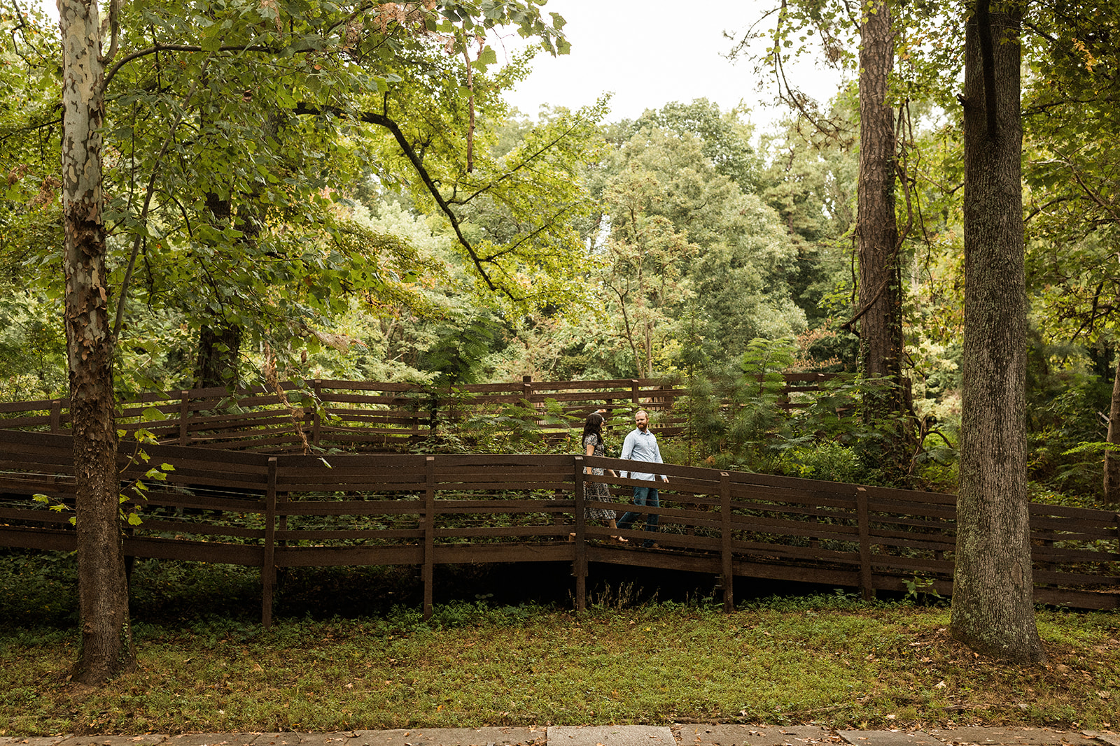 couple walking down wooden ramp near the james river in richmond virginia