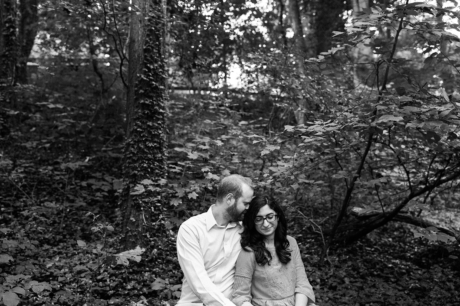 couple embracing in forest near richmond virginia