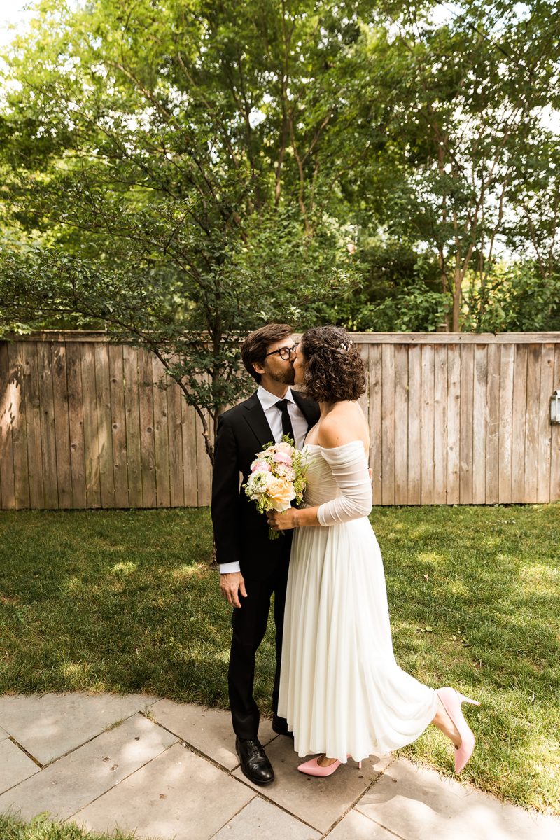 Bride and groom kissing in their backyard in Alexandria, Virginia