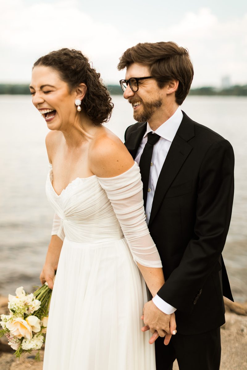 bride and groom laughing at alexandria waterfront