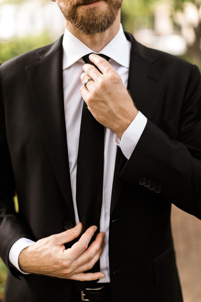 groom fixing his tie