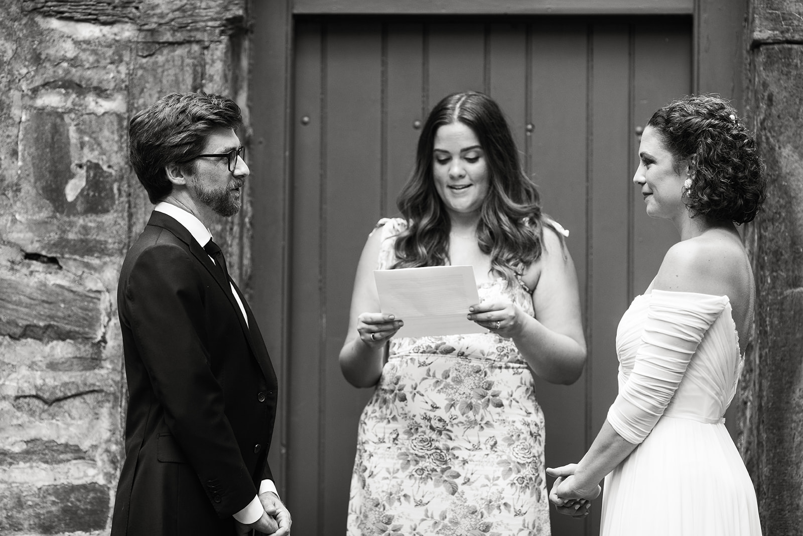 bride and groom exchanging vows during wedding ceremony at carlyle house