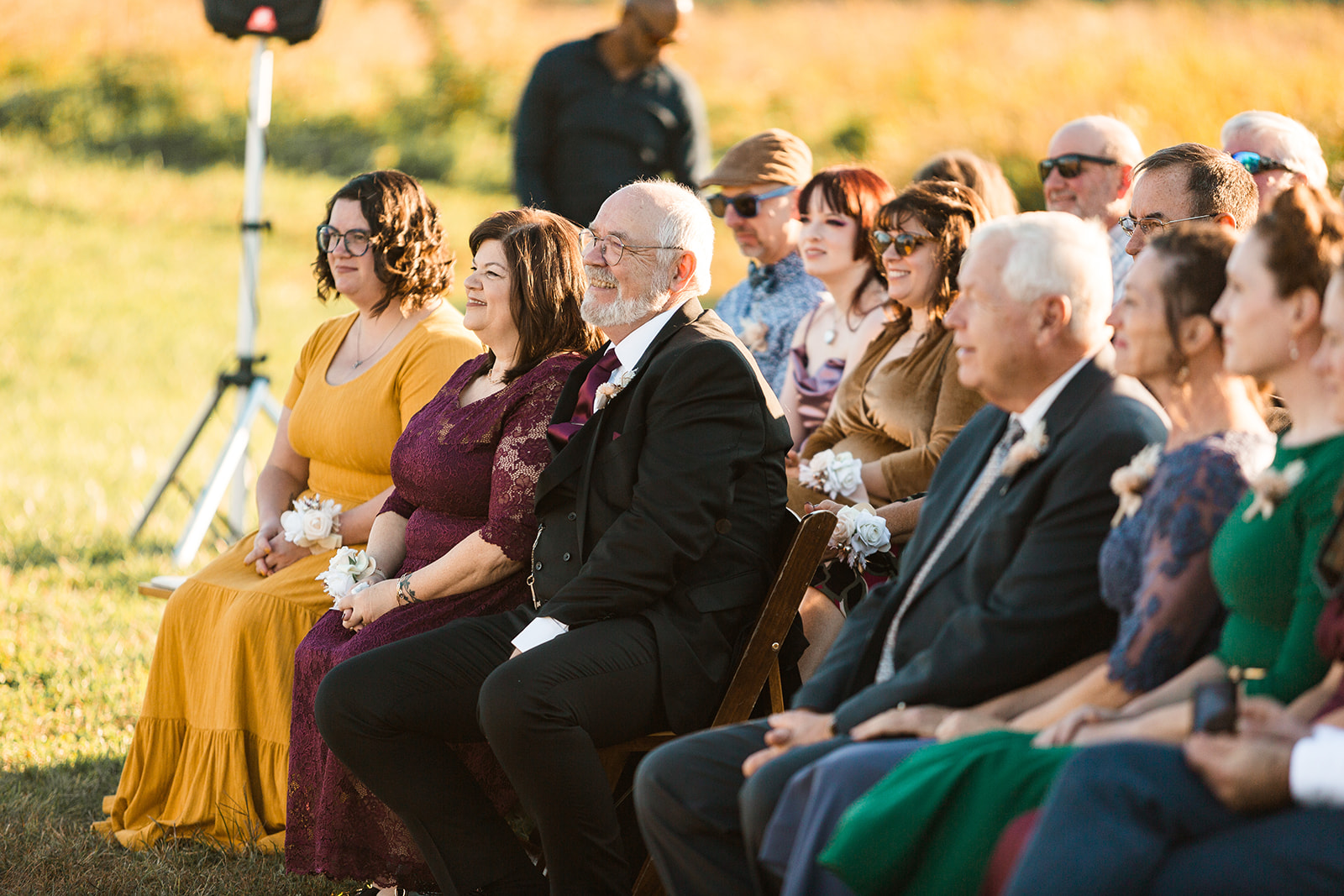 Wedding guests smiling watching wedding ceremony at National Arboretum in Washington, DC