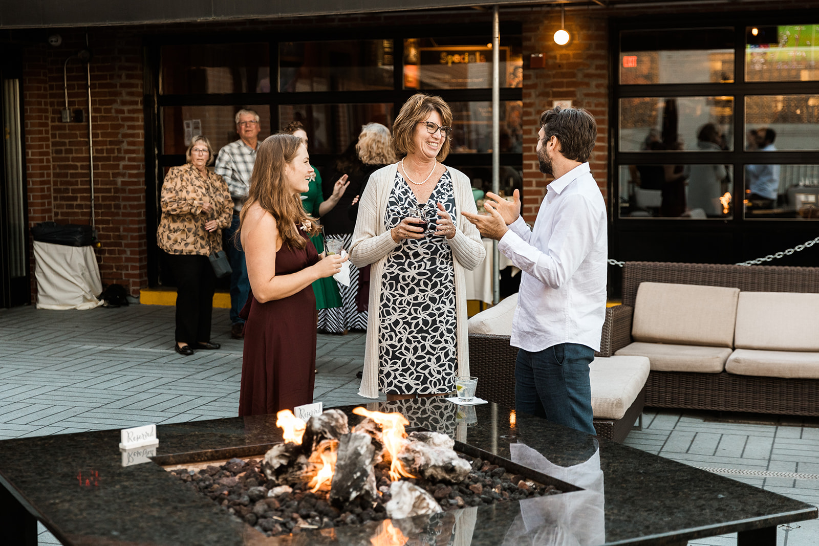 wedding guests enjoying cocktail hour on the patio at Smoke City in Washington, DC