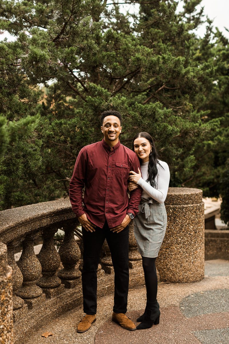 man and woman standing next to concrete railing in meridian hill park