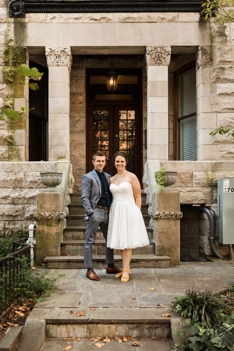 bride and groom posing in front of historic house in washington dc