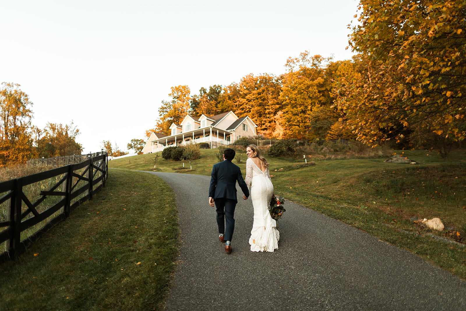 bride and groom portraits walking along the family farm