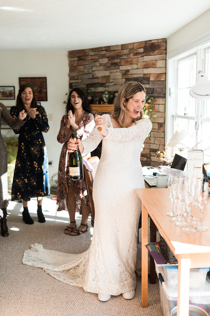 bride popping champagne