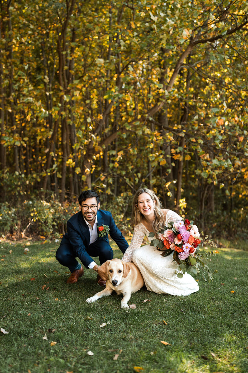 bride and groom portrait with their dog surrounded by lush forest landscapes in shenandoah