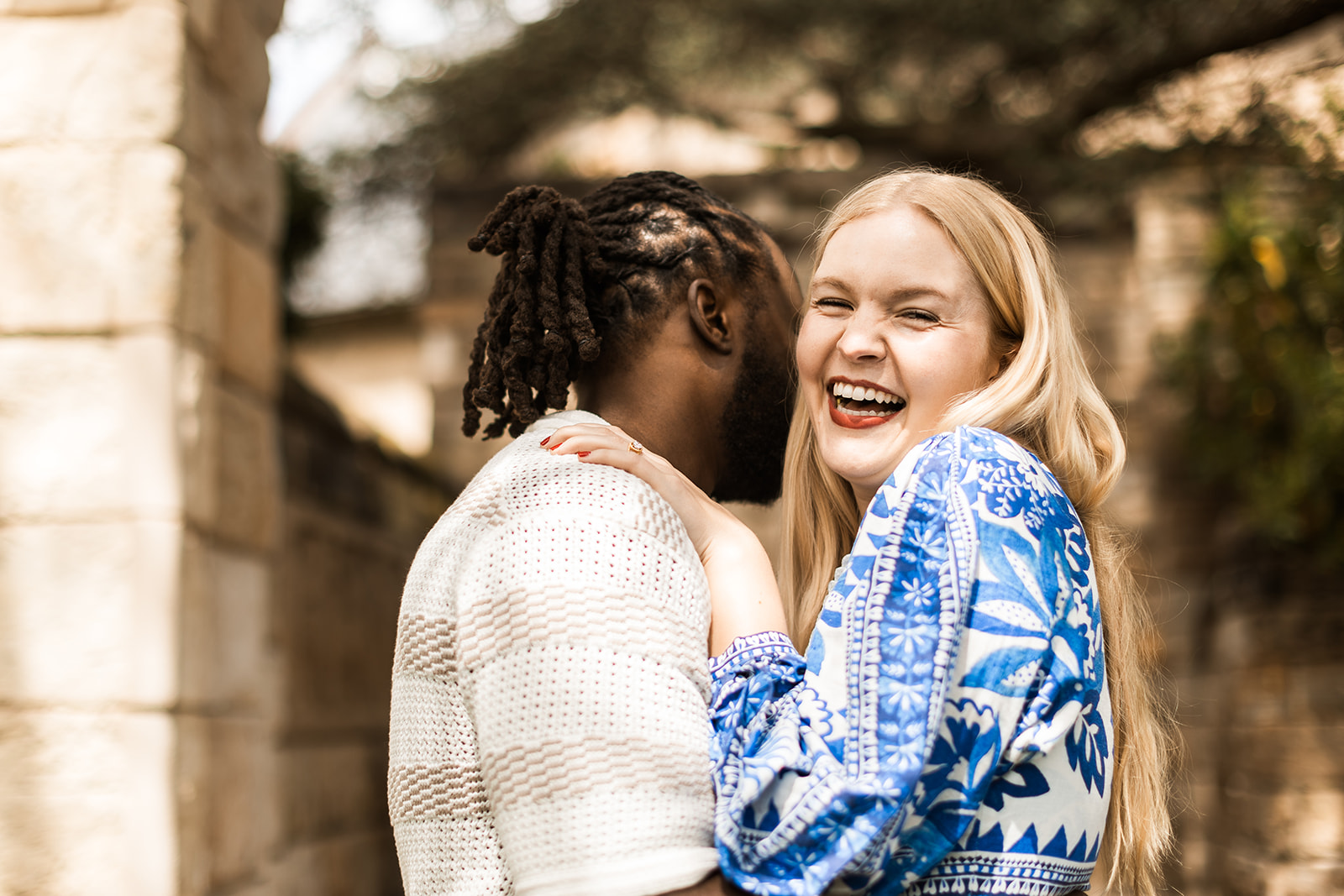 sweet and playful couple roaming the gardens for their engagement photos at the national cathedral in dc