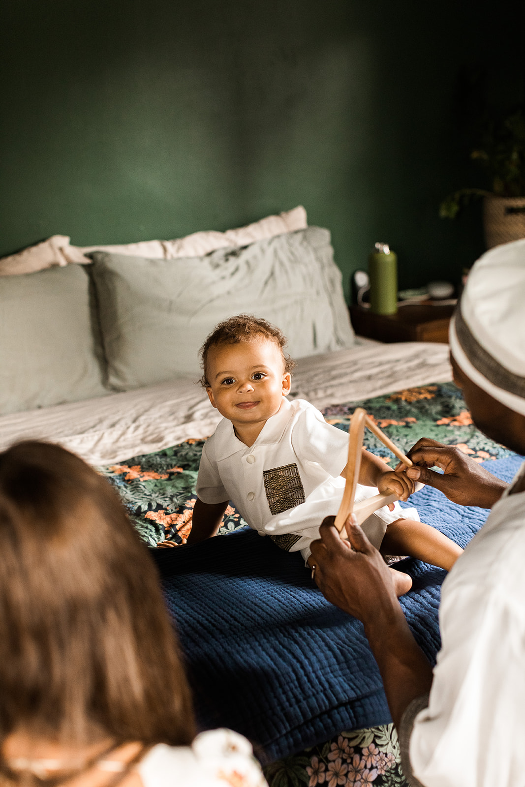 bride and groom getting their little son dressed up for their wedding
