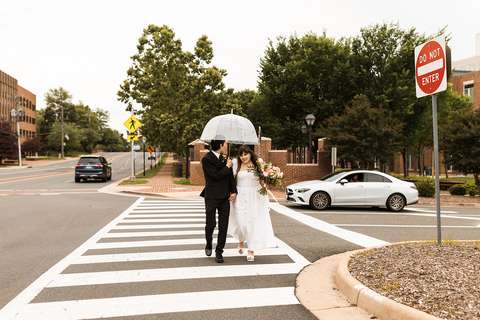 bride and groom roaming around rainy old town fairfax