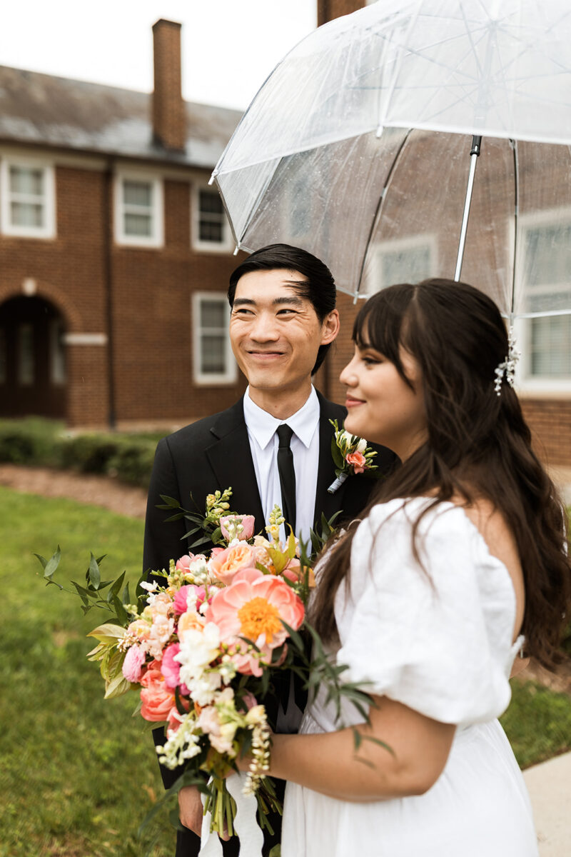 bride and groom roaming around rainy old town fairfax