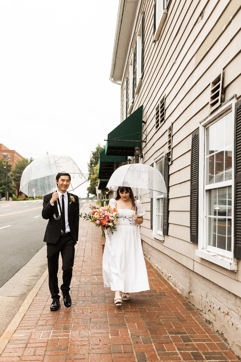 bride and groom roaming around rainy old town fairfax