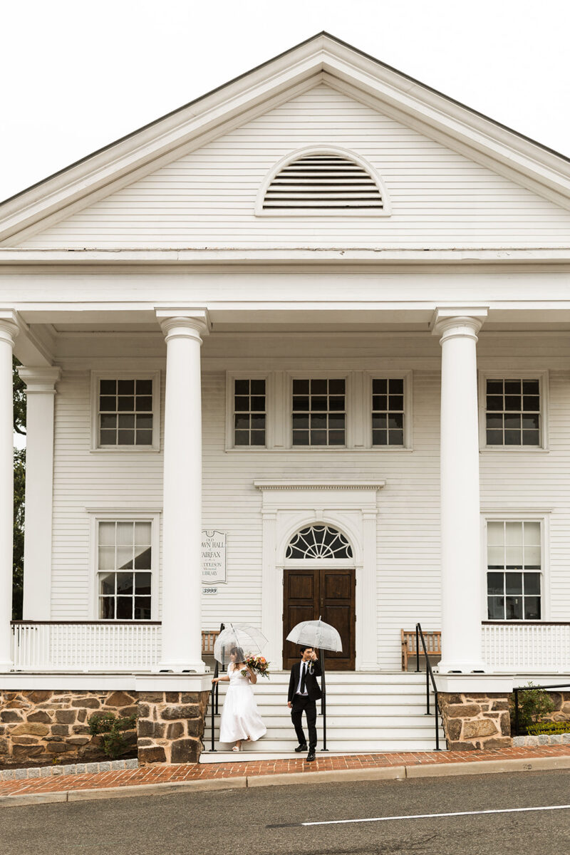 bride and groom roaming around rainy old town fairfax