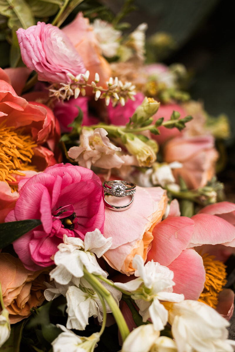 wedding rings on a colorful wedding bouquet
