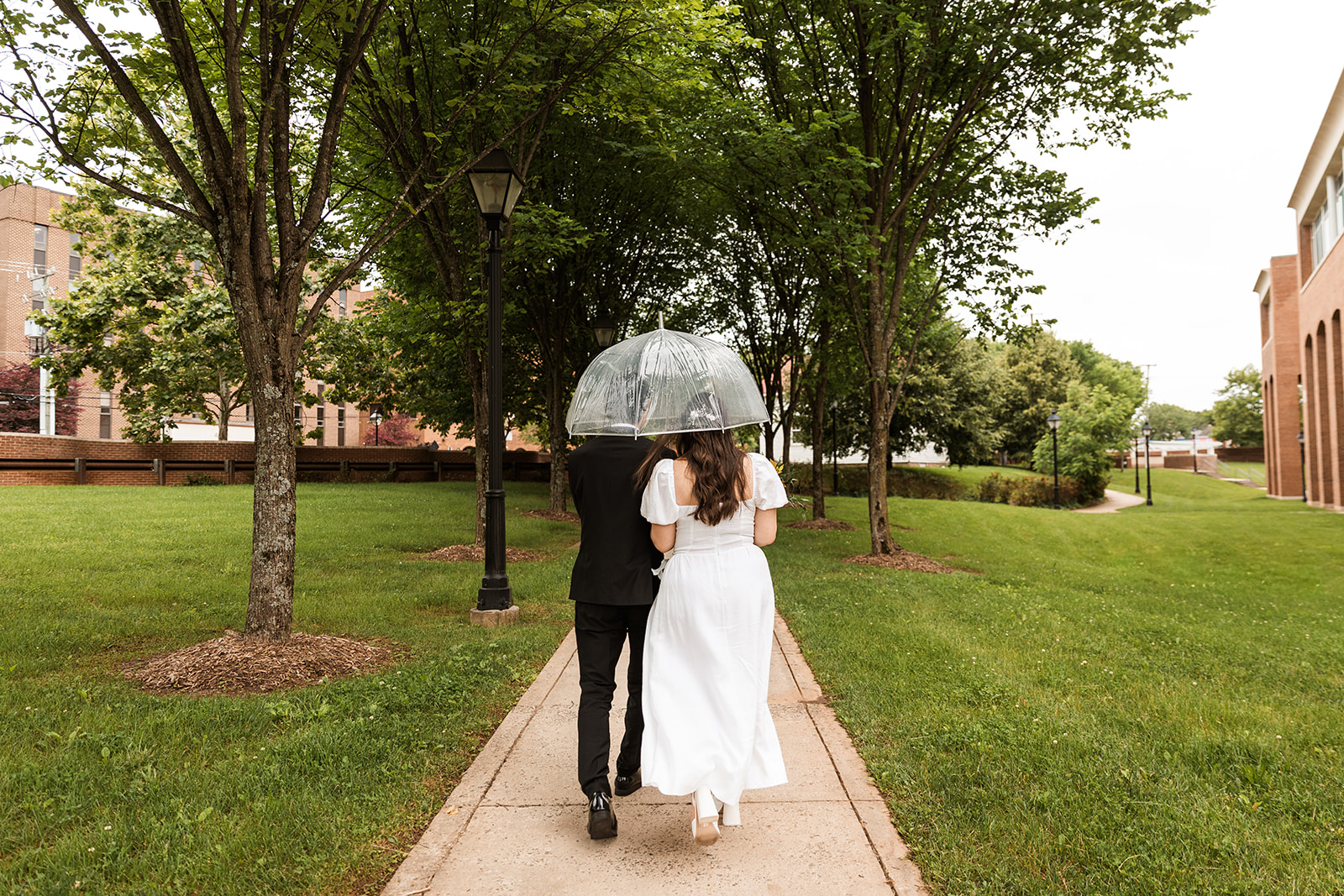 bride and groom roaming around rainy old town fairfax