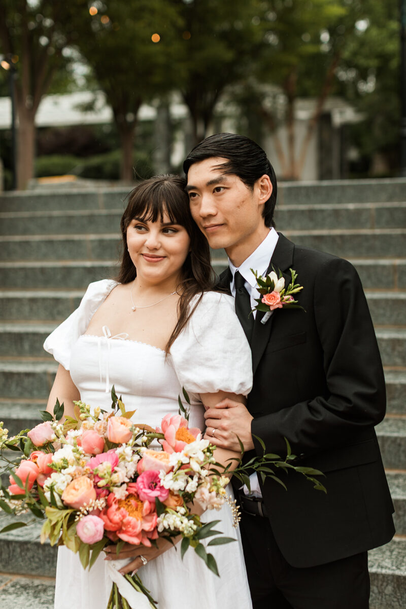 bride and groom posing on steps in the heart of old town fairfax